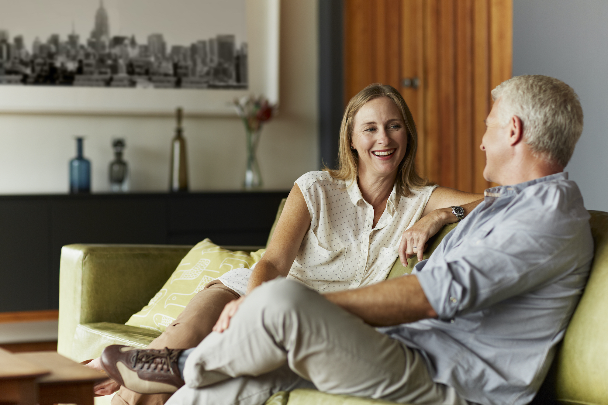 Midlife couple sitting on couch together